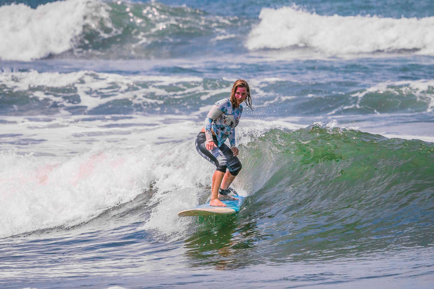 emma standing on a surfboard