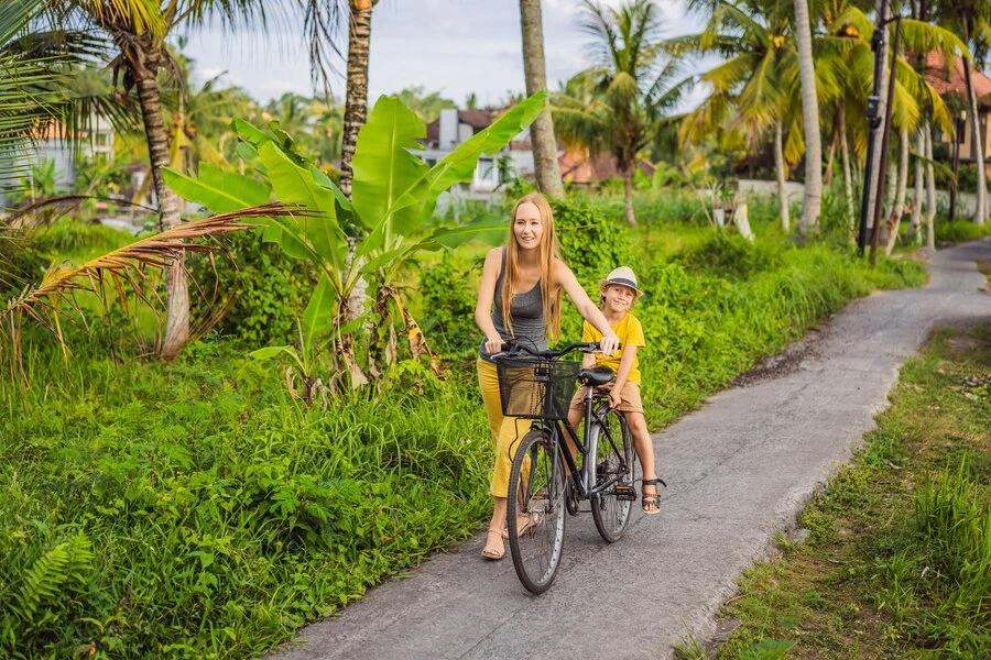 mother and son ride bicycle rice field ubud bali