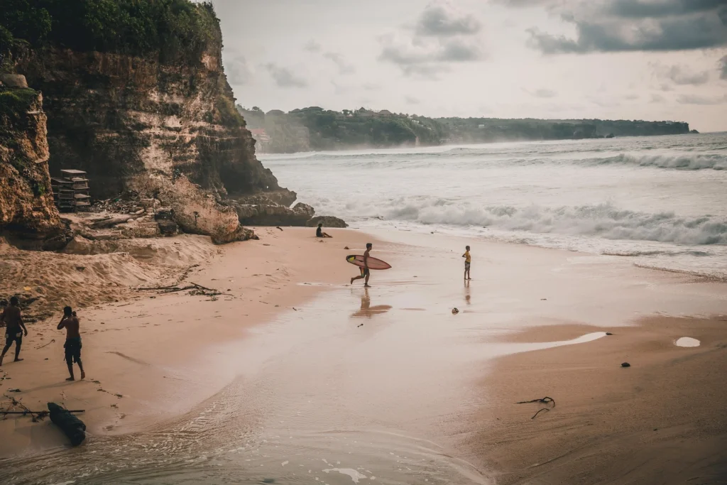 People surfing at a popular beach in Bali