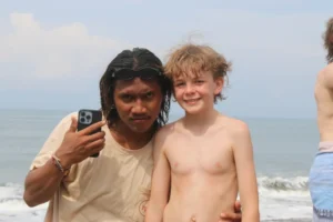Balinese surf guide with a young surfer at pelan pelan bali
